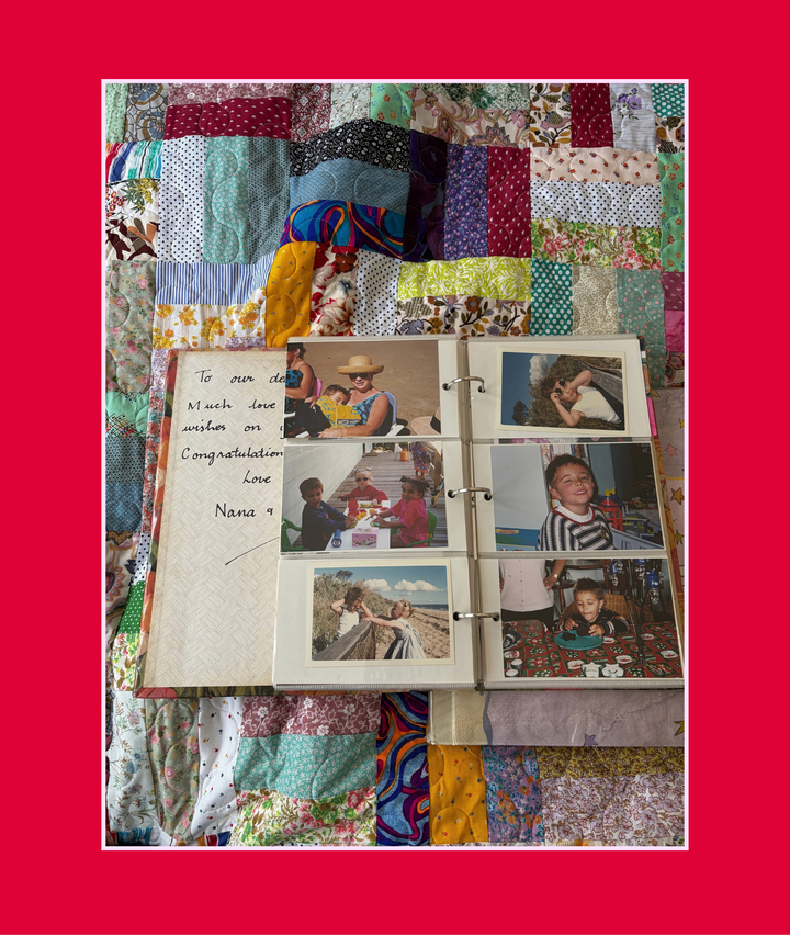 Old family photo album open on a patchwork quilt with a handwritten note from Nana